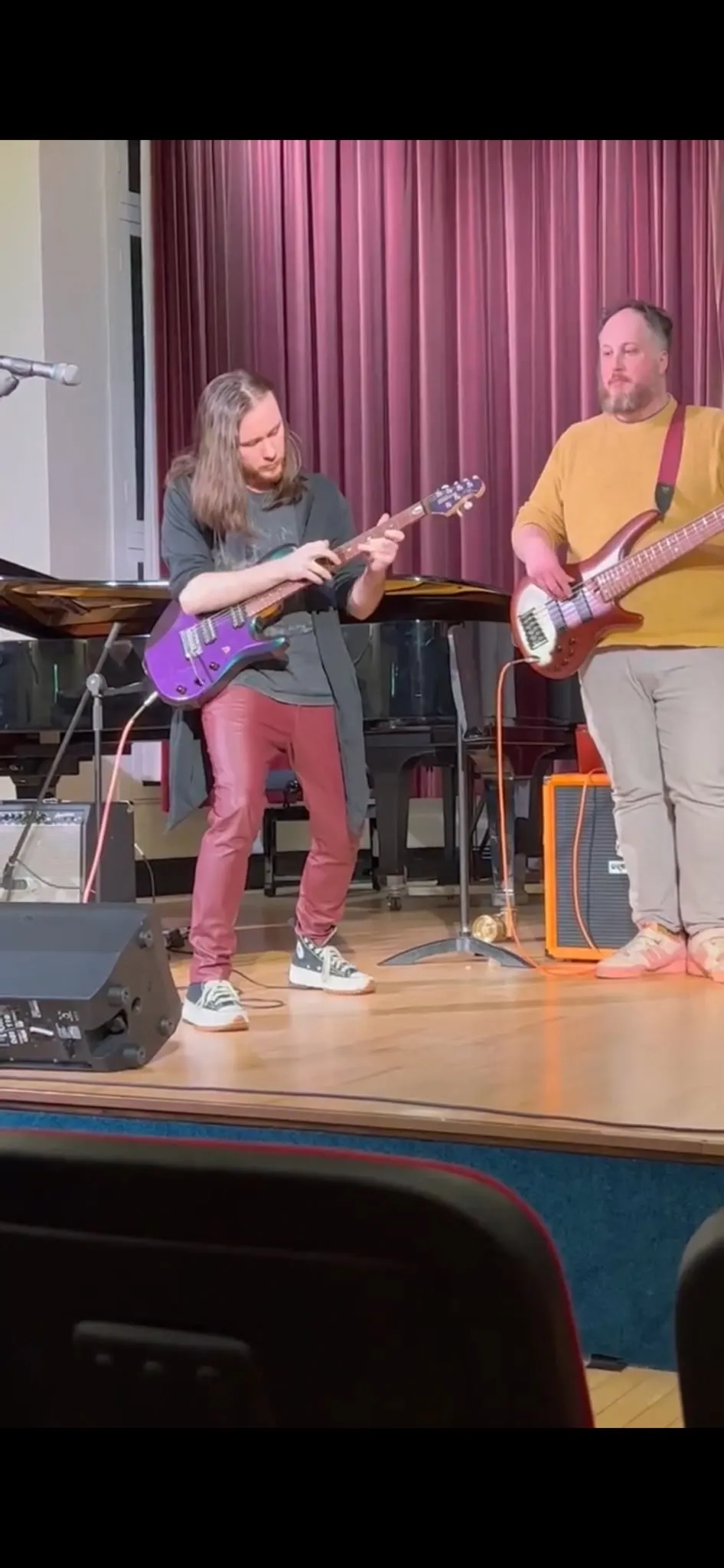 Jamie playing guitar alongside a bassist